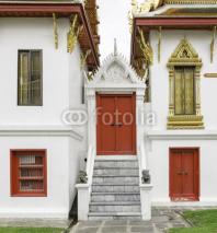 Naklejki Ancient red carving wooden door of Thai temple