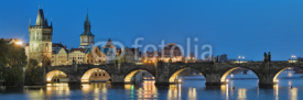 Fototapety Evening panorama of the Charles Bridge in Prague, Czech Republic, with Old Town Bridge Tower, Old Town Water Tower and dome of the National Theatre