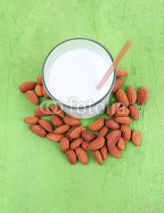 Fototapety Almond milk in jug with almonds in bowl,