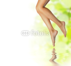 Naklejki healthy sexy slender female legs over spring background