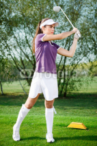 Naklejki Girl golfer hitting the ball