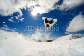 Fototapety Snowboarder going off jump doing a backflip