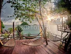 Fototapety Seculed terrace with wooden hammocks