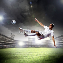 Fototapety football player striking the ball