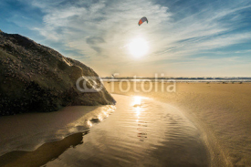 Naklejki Sunset on the beach of Tarifa, with solitary kiter