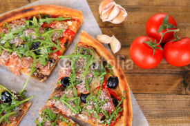 Fototapety Pizza with arugula on color wooden background