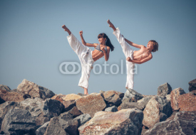 Fototapety Children training karate on the stone coast