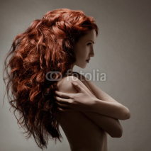 Naklejki Beautiful woman with curly hairstyle against gray background
