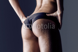 Naklejki female athlete rear view, trained buttocks