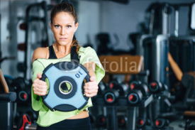 Obrazy i plakaty Weight exercising. Female athlete exercising with weight