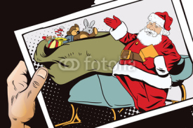 Fototapety Santa Claus near magical sleigh. Hand with photo.