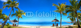 Obrazy i plakaty Tropical beach panorama with chairs and umbrellas