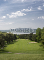 Naklejki Downhill hole with a beautiful view above the golf course