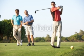 Fototapety Group Of Male Golfers Teeing Off On Golf Course