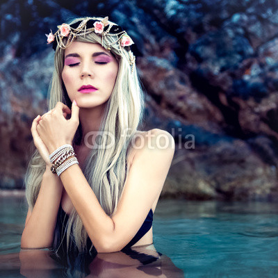 Portrait of sensual blond girl in a wreath in the sea