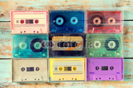 Obrazy i plakaty Top view (above) shot of retro tape cassette on wood table - vintage color effect styles.