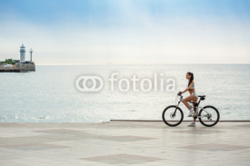 Fototapety A beautiful girl on the bike