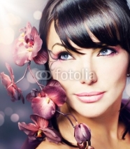 Naklejki Beautiful Healthy Woman with Orchid flower