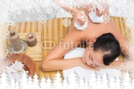 Fototapety Peaceful brunette enjoying a herbal compress massage