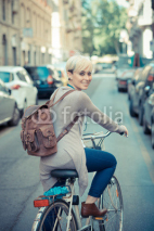 Naklejki beautiful young blonde short hair hipster woman with bike