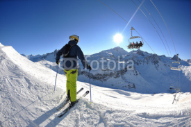 Naklejki skiing on fresh snow at winter season at beautiful sunny day