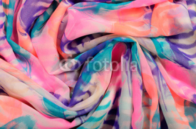 Fototapety Pink, turquoise and purple pattern on folded  fabric.