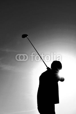 Silhouette of a Man Swinging a Golf Club
