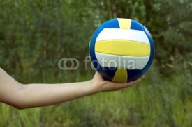 Obrazy i plakaty Female hand holds in her palm sports ball for playing volleyball