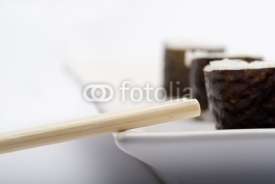 Obrazy i plakaty Composition of maki sushi, white late and a stick. 