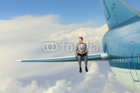 Fototapety On wing of flying airplane