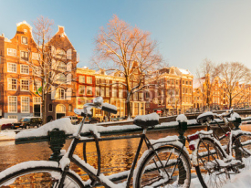 Naklejki Bicycles covered with snow during winter in Amsterdam