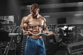 Fototapety Muscular man working out in gym doing exercises with barbell at biceps, strong male naked torso abs