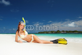 Fototapety Cute woman with snorkeling equipment relaxing on the tropical be