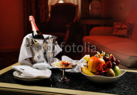 Fototapety Romantic evening with bottle of champagne, sweets and fruits