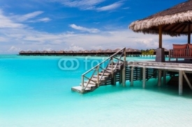 Fototapety Over water bungalow with steps into blue lagoon