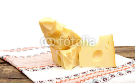 Naklejki piece of cheese on a wooden  table