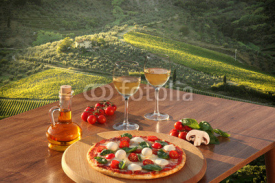 Obrazy i plakaty Italian pizza and glasses of white wine in Chianti, Italy