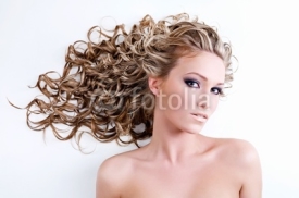 Naklejki Beautiful young woman with long curly hair