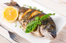 Fototapety Dorado fish with lemon and spices on a wooden board