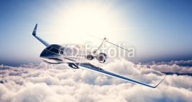 Obrazy i plakaty Photo of black luxury generic design private jet flying in blue sky. Huge white clouds and sun at background. Business travel concept. Horizontal. 3d rendering