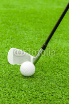 Fototapety golf ball on tee in front of driver on green course