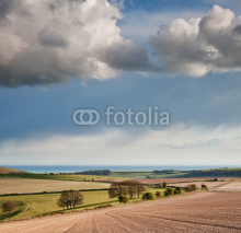 Naklejki Stunning landscape with stormy sky over rural hills