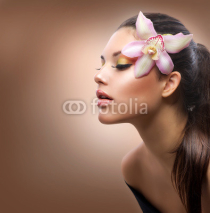Naklejki Beauty Portrait. Beautiful Stylish Girl with Orchid Flower