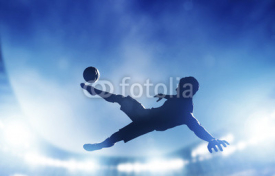 Obrazy i plakaty Football, soccer match. A player shooting on goal