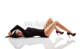 Naklejki Woman with a stunning body lying on floor