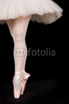 Naklejki A ballet dancer standing on toes while dancing artistic conversi