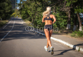 Obrazy i plakaty young woman jogging in the park in summer