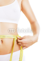 Naklejki close-up photo of sporty woman body with tapemeasure