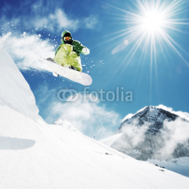 Obrazy i plakaty Snowboarder at jump inhigh mountains
