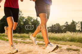 Naklejki Young Couple Jogging in Park